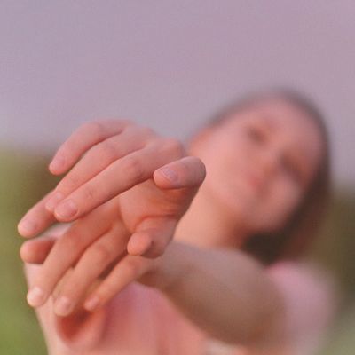 Close-up of a person performing a gentle stretch.